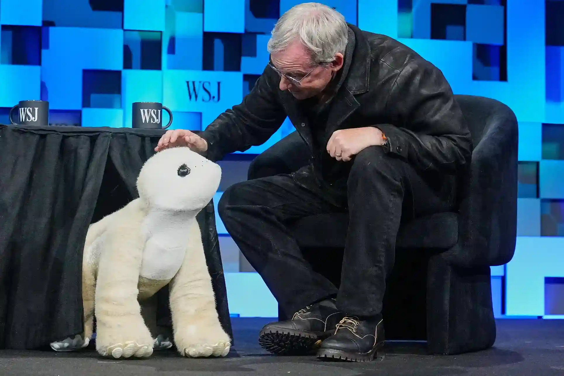 Colin Angle interacting with the Familiar AI-powered companion robot at the WSJ Future of Everything conference.