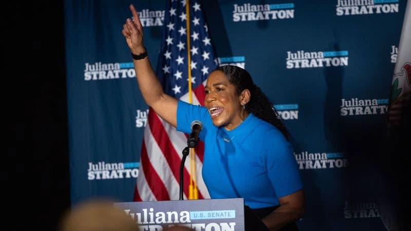 Juliana Stratton delivering victory speech after winning Illinois Democratic Senate primary, celebrating with supporters and campaign signage