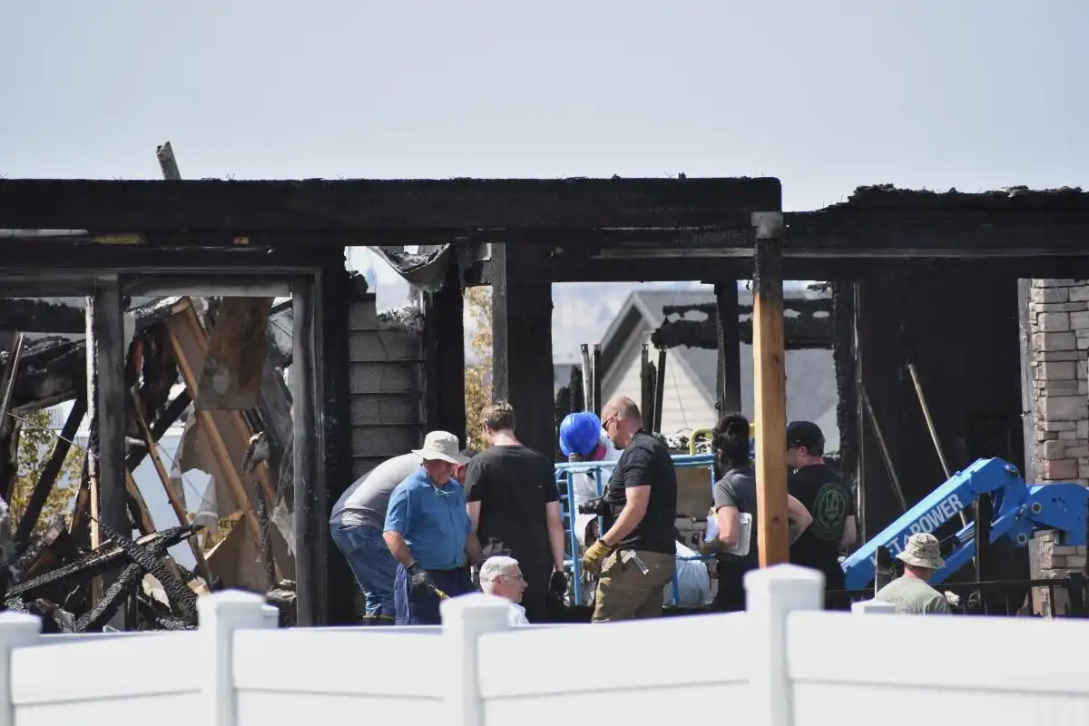 Investigators search a burned Montana home after eight family members were killed in a shooting