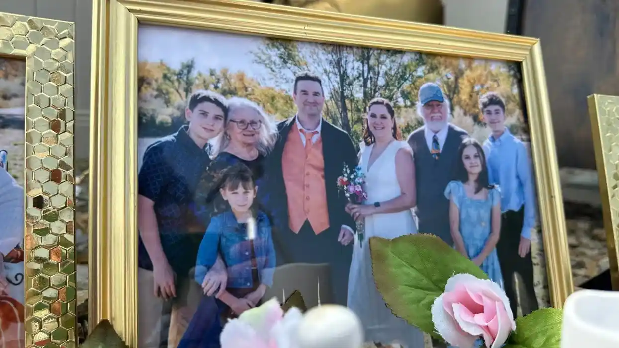 Framed family photo displayed near a memorial for victims of the Montana family killings