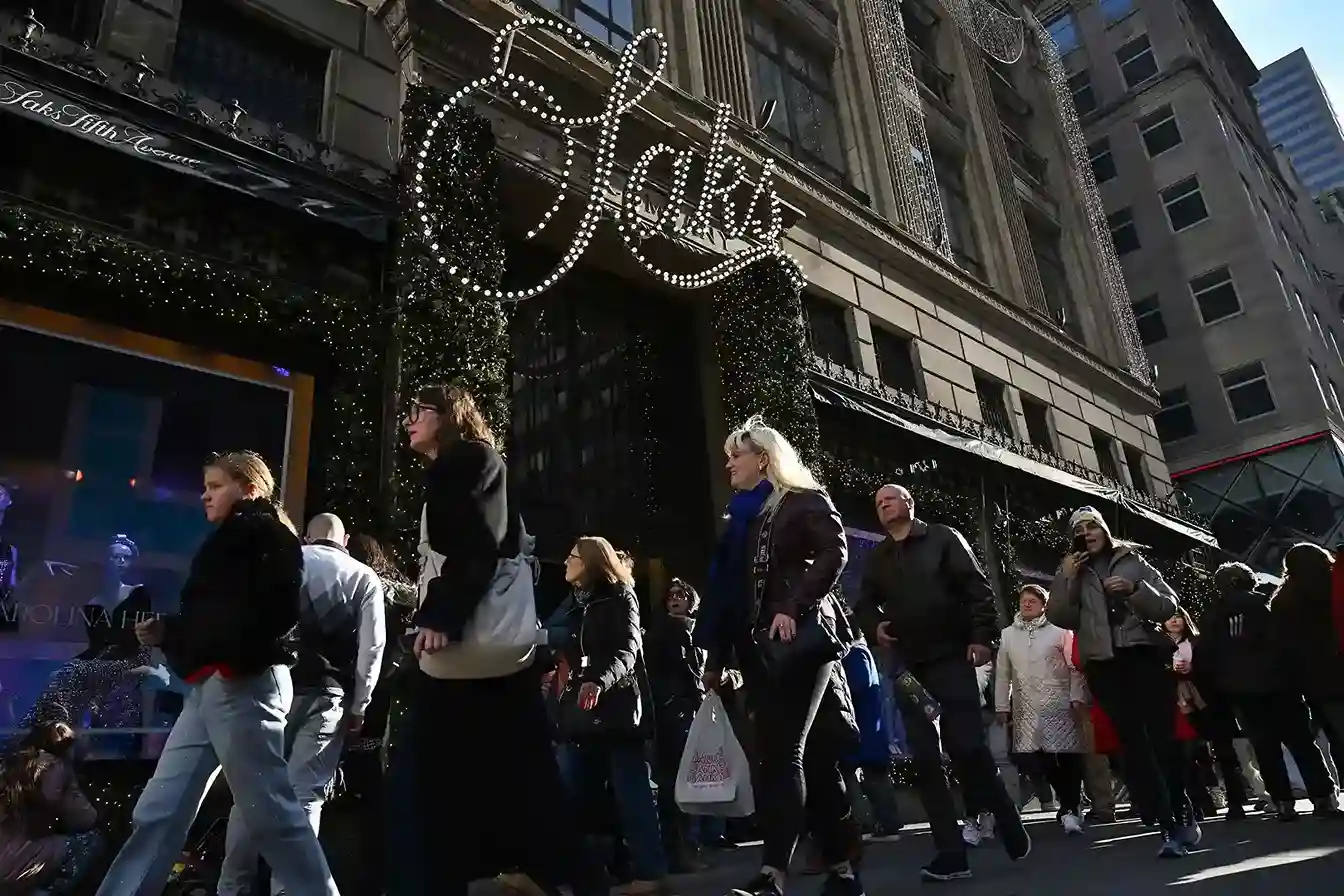 Shoppers outside Saks Fifth Avenue store during peak luxury retail shopping period