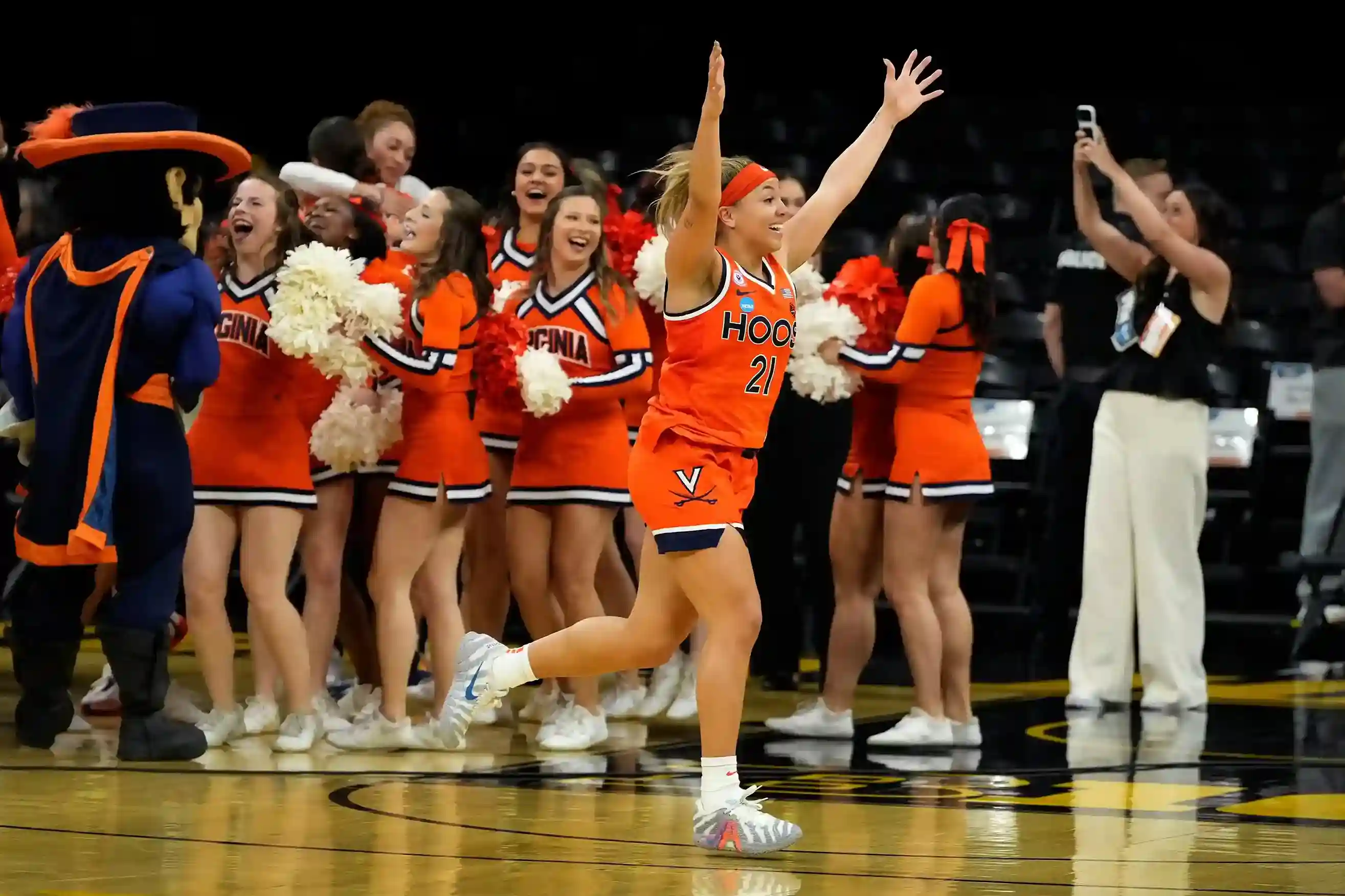 Kymora Johnson celebrates with arms raised after Virginia Cavaliers upset Iowa in double overtime during the NCAA Women’s Basketball Tournament