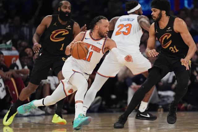 Jalen Brunson drives through Cleveland Cavaliers defenders during Knicks vs Cavaliers Eastern Conference Finals Game 1.