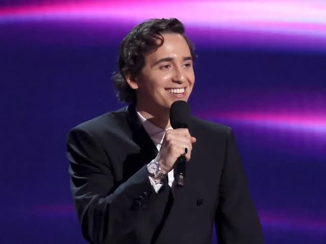 Marcello Hernández speaking into a microphone while hosting the 2026 ESPY Awards on stage at the David H. Koch Theater in New York City.